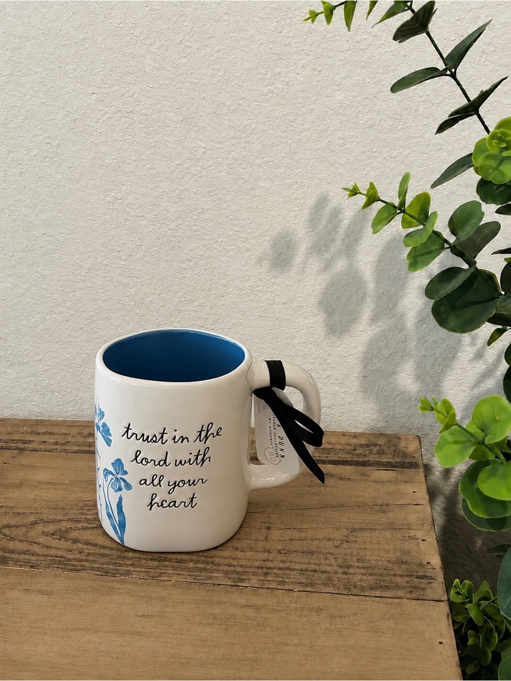 Rae Dunn “trust in the lord with all your heart” mug with light blue flowers.